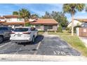 Charming single-story home with a red tile roof, palm trees and dedicated parking at 7360 Ulmerton Rd # 17D, Largo, FL 33771