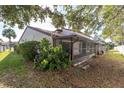Enclosed patio with screen and lush landscaping surrounds the home at 7360 Ulmerton Rd # 17D, Largo, FL 33771