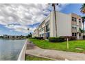 Exterior of building on the water, showing landscaped lawn and trees at 7425 Bay Island S Dr # 203, South Pasadena, FL 33707