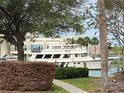 View of the waterfront with a large boat docked in front of the building at 7425 Bay Island S Dr # 203, South Pasadena, FL 33707