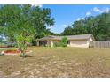 Attractive single-story home featuring a lush front yard, well-placed trees, and a cozy, welcoming facade at 8309 Pebble St, Spring Hill, FL 34608