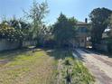 View of a spacious front yard with a brick-lined driveway leading to the house at 943 7Th N St, St Petersburg, FL 33701