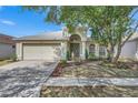 Attractive single-story house featuring a manicured lawn and a welcoming front entrance at 10048 Creek Bluff Dr, Riverview, FL 33578