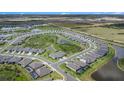An aerial view of a Primary-planned community featuring winding roads and scenic ponds at 10418 Spring Tide Way, Parrish, FL 34219