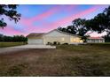 Exterior view of home, showing the attached garage, extra garage and spacious backyard at 1202 Williams Rd, Plant City, FL 33565