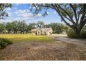 Inviting single-story home on a large lot, surrounded by mature trees and lush landscaping at 1202 Williams Rd, Plant City, FL 33565