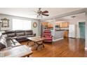 Open-concept living room featuring hardwood floors and a comfortable leather sofa at 1310 Hilton Pl, Tampa, FL 33604