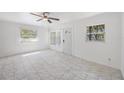 A serene living space boasting bright, natural light and marble flooring, creating an open atmosphere at 1341 Sandy Ln, Clearwater, FL 33755