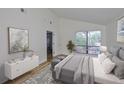 Bright main bedroom featuring a large window and ensuite bathroom at 13703 Sweetwater Cove Pl, Tampa, FL 33613