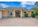 Close-up of the elegant front entrance featuring stone accents, columns, and double doors at 19815 Sea Rider Way, Lutz, FL 33559