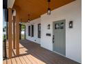 Charming front porch with wood columns, modern lighting fixtures, and a freshly painted exterior, creating a welcoming entrance at 2718 N 21St St, Tampa, FL 33605