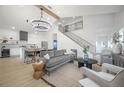 Bright, modern living room with a large chandelier, open to the kitchen and stairs at 2718 N 21St St, Tampa, FL 33605