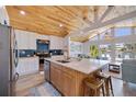 Bright kitchen featuring stainless steel appliances, a large island, and an open floor plan with vaulted ceilings at 300 10Th Ave, Indian Rocks Beach, FL 33785