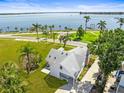 Scenic aerial view showcasing home's proximity to waterfront, lush landscaping, and charming neighborhood at 308 Chauncey Ave, Bradenton, FL 34208