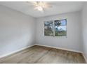 Bright bedroom featuring new flooring, a ceiling fan and a window overlooking the outdoors at 314 Barlow Ave # 73, Sarasota, FL 34232