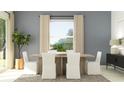 Bright dining area with a wood table, white chairs, and neutral curtains at 31670 Cannon Rush Dr, San Antonio, FL 33576
