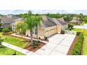 View of the home showcasing a manicured lawn and ample driveway space at 3227 Watermark Dr, Wesley Chapel, FL 33544