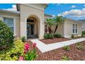 Inviting entryway with a walkway leading to a glass-paned front door at 3227 Watermark Dr, Wesley Chapel, FL 33544