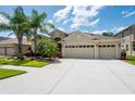 This home features a three-car garage, neutral color scheme and well-maintained landscaping at 3300 Stonegate Falls Dr, Land O Lakes, FL 34638