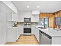 Modern kitchen with stainless steel appliances, white cabinets, and quartz countertops at 3316 W Napoleon Ave, Tampa, FL 33611
