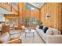 Bright living room with vaulted ceilings, wood paneling, and large windows for natural light at 3316 W Napoleon Ave, Tampa, FL 33611