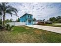 Charming two-story home featuring a quaint front porch, private white fence, and spacious front driveway at 3402 W Clifton St, Tampa, FL 33614