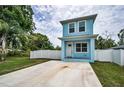Charming two-story home featuring a quaint front porch, private white fence, and spacious front driveway at 3402 W Clifton St, Tampa, FL 33614