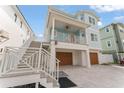 Beautiful home showcasing a two-car garage and covered outdoor living space with private entrance at 371 12Th Ave, Indian Rocks Beach, FL 33785