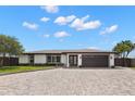 Charming one-story home with manicured lawn and a circular brick driveway at 4331 13Th Ne Way, St Petersburg, FL 33703