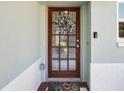 Elegant front door adorned with a floral wreath, welcoming guests to this charming home at 460 4Th S St, Safety Harbor, FL 34695