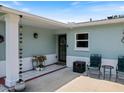 Cozy front porch with charming decor, including chairs and decorative plants, for relaxed outdoor enjoyment at 460 4Th S St, Safety Harbor, FL 34695