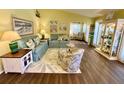 Cozy living room featuring tile floors, comfortable sofas, and nautical decorations at 4740 Carrington Ct # 4740, New Port Richey, FL 34655