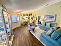 Bright and airy living room with tile floors, stylish seating, and dining area view at 4740 Carrington Ct # 4740, New Port Richey, FL 34655