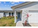 Charming single-story home with stone accents, front yard flower bed, and a gray garage door at 507 Hammock Dr, Palm Harbor, FL 34683