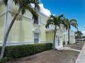 Bright yellow condos trimmed in white offer charming curb appeal with lush tropical landscaping at 5225 Coquina Key Se Dr # B, St Petersburg, FL 33705