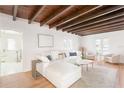 Spacious living room with exposed wood beam ceiling and stylish white sectional couch at 53 Albemarle Ave, Tampa, FL 33606