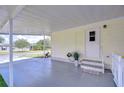 Spacious carport featuring concrete flooring and convenient access to the home's entrance at 5721 Apache St, Zephyrhills, FL 33542