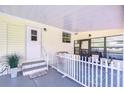 Covered porch with picket fence, offering an inviting outdoor seating area at 5721 Apache St, Zephyrhills, FL 33542