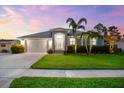 Well-kept home with a green lawn, palm trees, and a two-car garage, creating a pleasant curb appeal at 6121 33Rd N Ave, St Petersburg, FL 33710