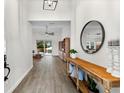 Inviting hallway with wood-look tile, leading to a living area, and enhanced with a stylish console table at 6121 33Rd N Ave, St Petersburg, FL 33710