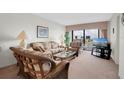 Relax in this cozy living room, with views from the balcony and a comfortable seating area at 7150 Sunset Way # 405, St Pete Beach, FL 33706