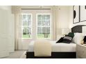 Well-lit bedroom with sleek furnishings, modern decor, and ample natural light streaming through large windows at 7776 Painted Sky Pl, Land O Lakes, FL 34637