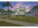 Inviting two-story home featuring a well-maintained lawn, lush landscaping, and a charming walkway to the front entrance at 785 52Nd N Ave, St Petersburg, FL 33703