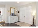 Bright foyer featuring a console table with decor, dark wood floors, and access to other rooms at 805 Bannockburn Ave, Temple Terrace, FL 33617