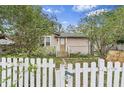 Cozy home with a welcoming white picket fence and stone pathway at 10803 N Florence Ave, Tampa, FL 33612