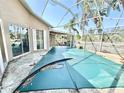 Screened-in pool with outdoor space, privacy fence and foliage at 1145 Riveredge Dr, Tarpon Springs, FL 34689