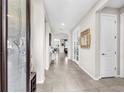 Inviting home foyer featuring light tile flooring, high ceilings, and neutral-colored walls at 11606 Kilkenny Coral Dr, Riverview, FL 33579