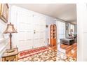 Open foyer with mosaic tile, leading to hardwood floors and the living area at 12303 Fieldstone Ln, Hudson, FL 34667