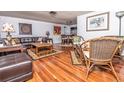 Spacious living room featuring hardwood floors, leather furniture, and elegant decor at 12303 Fieldstone Ln, Hudson, FL 34667