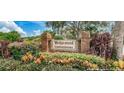 Welcoming community sign for Wedgewood Condominiums surrounded by colorful landscaping at 12804 Wedgewood Way # C, Hudson, FL 34667
